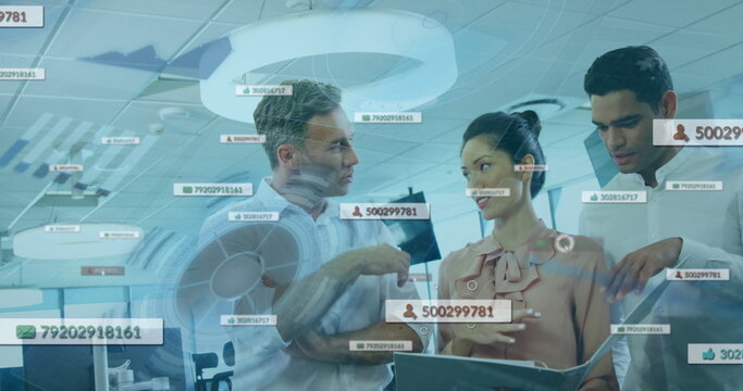 Discussing colleagues in business attire reviewing data on tablet in open office, with overlays