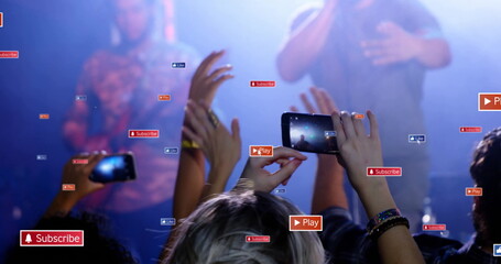 Recording fans raising smartphones and hands at live music venue, with smoke haze and overlay icons