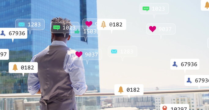 Standing man in vest and shirt overlooking skyline from balcony, with floating notification icons