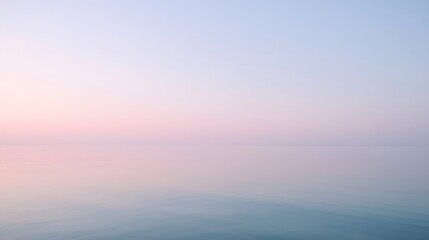 Fototapeta premium Calm pastel pink and blue horizon over a smooth sea during sunset, creating a serene and minimalistic atmosphere perfect for backgrounds, wellness, relaxation, and nature-themed designs