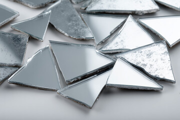 Broken Mirror Pieces on White Surface