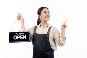 Portrait young asian barista woman wearing apron holding open sign for inviting customer to enter with happiness, waitress woman holding signboard with open, small business or startup business.