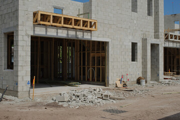 Fototapeta premium Construction Site Showcasing Building Frames with Utility Preparations in Progress. Elevated view of a construction site with visible utility installations, foundations, and building frames. The setti