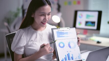 Asian businesswoman presenting business result using video call - Powered by Adobe