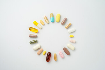 Clock made of pills capsules, pills form a circle, omega, vitamins, Cod liver oil, supplements
