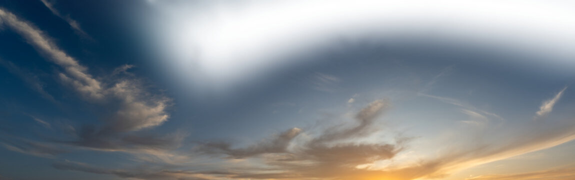 Late day sky as the setting sun colors some clouds with a partially transparent sky
