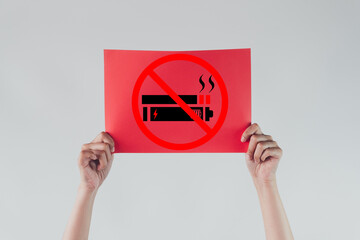 Hands holding an red paper with No smoking and no vaping sign icon Concept of quitting smoking and vaping for better health.,campaign for a healthy, smoke-free lifestyle.white background.