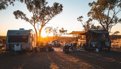 Sunset campground scene.  Campers under trees.  Golden light