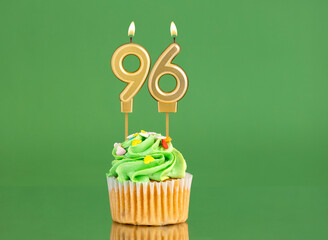 Number 96 birthday candle - Cupcake on a green background