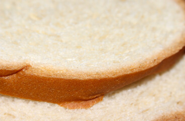 Closeup on a piece of bread, with blur in the background. Freshly baked bread. loaf with selective focus.
