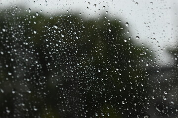 Obraz premium water drop on mirror in rainy day, blur natural background