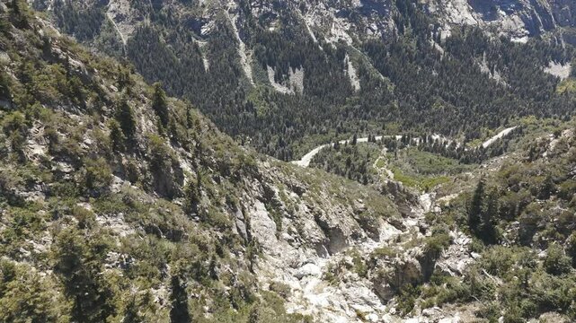 Aerial-Descending to traffic on distant mountain highway