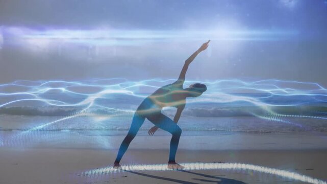 Yoga practitioner inhaling and raising arm on beach while digital health waves intensifying