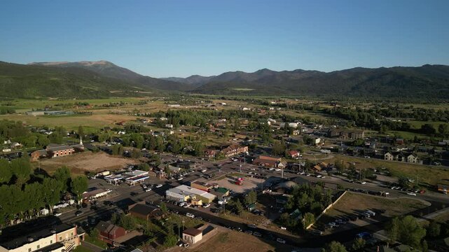 Low aerial above mountain town of Victor Idaho in summertime