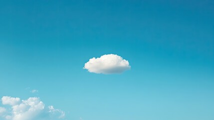 Single, puffy white cumulus cloud against a vibrant azure sky