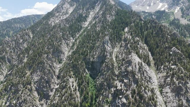 Aerial-Flying toward rugged granite mountain in Little Cottonwood Canyon, Utah