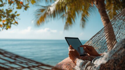 Relaxing in a Hammock by the Tropical Beach with a Tablet Device