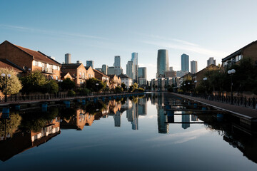 Modern skyline reflecting in calm waters of london docklands