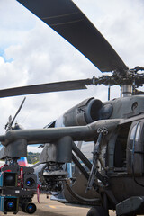Military Helicopter Displayed at Air Show with Weapons Visible