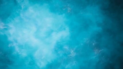 Aerial view of oceanic waters showcasing vibrant turquoise and cyan hues depicting ocean texture