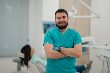 Portrait of smiling dentist with patient in background at dental clinic