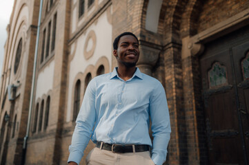 Elegant businessman smiling outside a church building