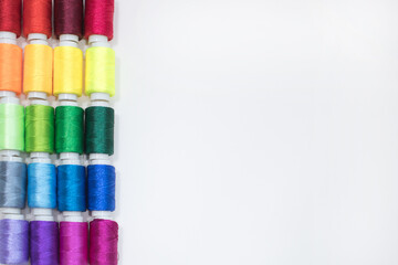 Flat Lay of Colorful Thread Spools in Rows with Copy Space on the Right