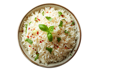 A top view of a bowl of white rice garnished with basil leaves and red pepper flakes on dark background
