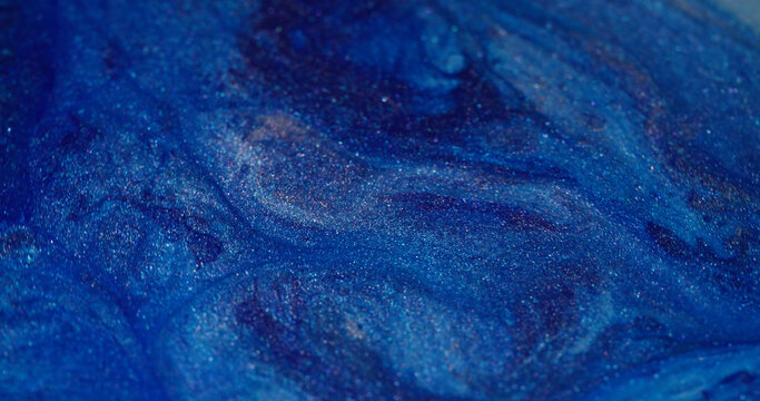 Ink stream. Floating splash. Defocused bright blue color spatter shimmer water texture spreading on abstract creative art background.