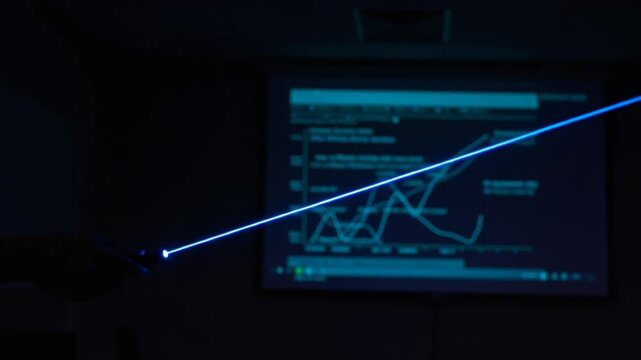 Person using laser pointer to highlight data trends