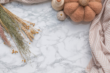 Minimalist autumn composition with soft pastel textiles, dried herbs, wheat stalks and neutral...