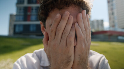 Close up tired unhappy Caucasian man covering face hands grief problems exhausted employee work...
