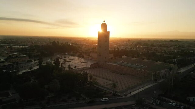Drone aerial view of the Medina, the souks and Jemaa el-Fna square in Marrakech at sunrise, capturing the historic heart of Morocco from above with its rooftops, alleys and vibrant market life