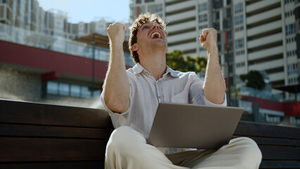 Happy Caucasian man business city freelancer working laptop computer win victory emotional male...