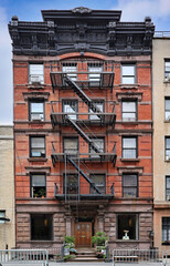 Old New York City apartment building with ornate roof cornice