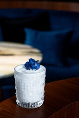 Gourmet Cocktail with Pink Foam and Floral Accent