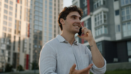 Caucasian man talking mobile phone smartphone call speaking communication gadget happy male guy...