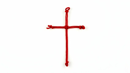 Symbol A cross mark crafted from red string, styled in a threaded concept, viewed in flatlay layout on white background (1)