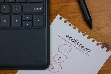 Keyboard and Paper Checklist with Pen Indicating Planning or Task Prioritization