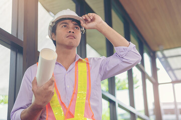 Smart civil architect engineer inspecting and working, command at outdoors building side with blueprints. Engineering and architecture concept