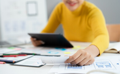 UI and UX designs for mobile app on laptop computer screen. User interface development planning for...
