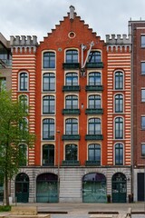 Discover the architectural beauty of Antwerp, Belgium, with this image of a historic warehouse. Its unique brickwork highlights the urban charm of Antwerp, Belgium.