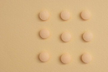 Minimal Health Concept – White and Peach Pills on Neutral Background for Pharmaceutical or Wellness Use