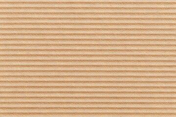 A close-up view of a corrugated cardboard texture background. The texture is characterized by parallel ridges and furrows, adding depth and dimension to the surface