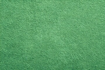 Fototapeta premium A detailed close-up of an eye-catching, vibrant green carpet. The texture of the carpet is visible, and the color is a bright, inviting green