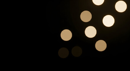 Abstract Bokeh Circles of Warm Light on Black Background.