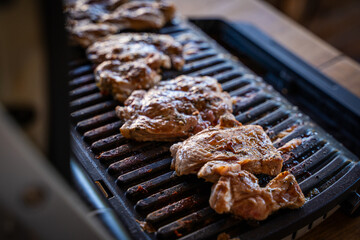 Pork steak being grilled on an electric grill, close-up