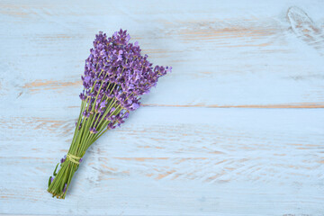 Bouquet of lavenders flower on light blue wooden background .	