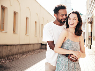 Naklejka premium Smiling beautiful woman and her handsome boyfriend. Woman in casual summer clothes. Happy cheerful family. Female having fun. Sexy couple posing in the street at sunny day
