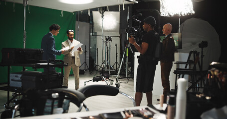 Man, filming and stabilize with, journalist in studio of broadcast, production process and record. People, crew and cinematographer on set for shooting news, documentary footage and scene rehearsal